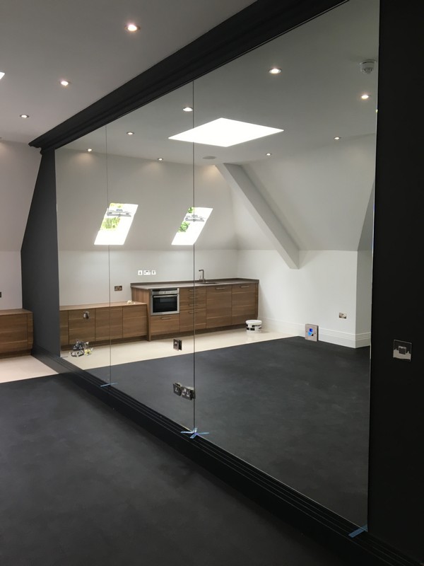 Frameless glass partition in loft conversion by Hemel Hempstead glaziers