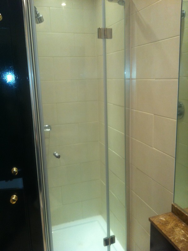 Frameless glass shower enclosure with chrome fittings in Hemel Hempstead