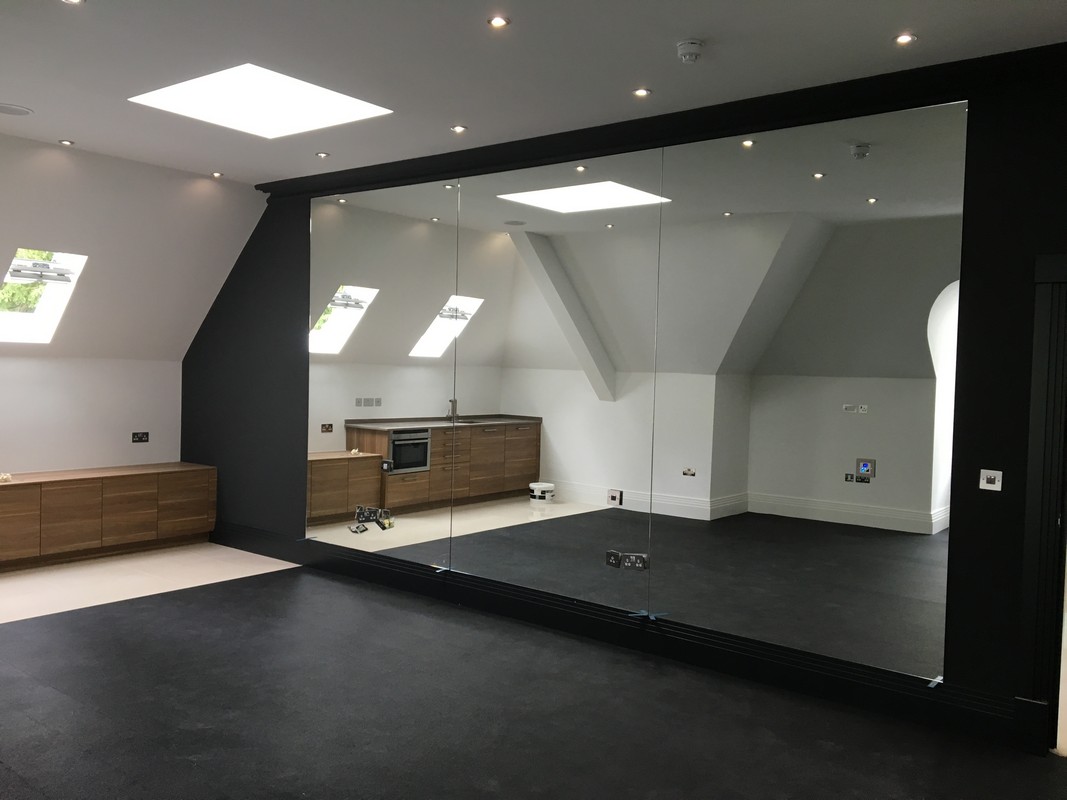 Frameless glass wall dividing loft conversion in Hemel Hempstead