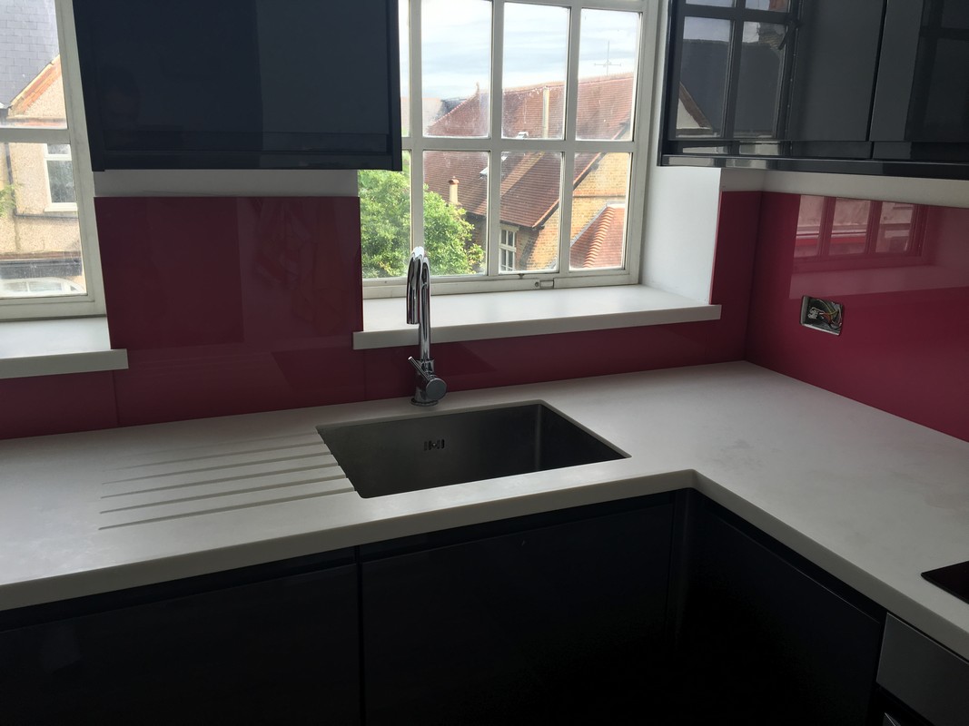 Deep plum coloured glass splashback in modern Hemel Hempstead kitchen